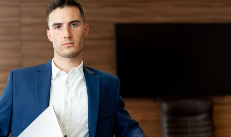 a man standing with a laptop